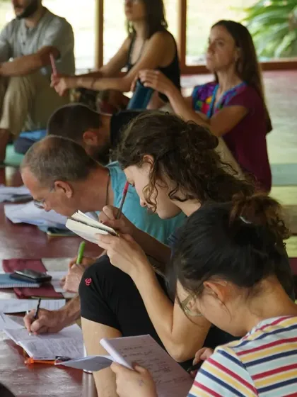 Students deeply engaged during a lecture, taking notes to absorb the ancient wisdom of Ayurveda. Our courses are designed for dedicated learners who want to truly understand these profound concepts.