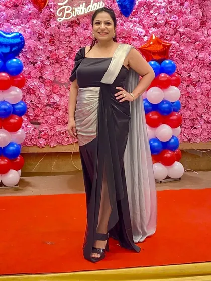 My client looks absolutely stunning in this custom-made black and silver gown. The one-shoulder design and draped silhouette are incredibly flattering, making it a perfect choice for a special birthday celebration.