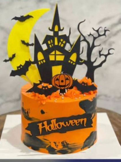 Happy Halloween! A spooky and fun cake with a haunted house, bats, and a pumpkin, perfect for a Halloween party.