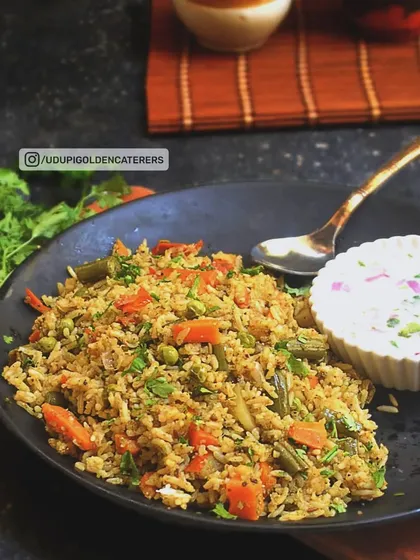 A look at our Vangibath, a traditional Karnataka rice dish made with a special spice blend, fresh vegetables, and garnished with coriander. This wholesome dish is a popular choice for breakfast and lunch catering.