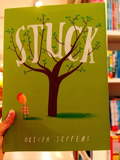 'Stuck' by Oliver Jeffers is a hilarious and absurdly brilliant story about a boy who gets his kite stuck in a tree, and the increasingly silly things he throws up to get it down.