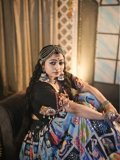 A seated portrait from the 'Halo re Halo' set, capturing a moment of quiet grace amidst the festive energy.
