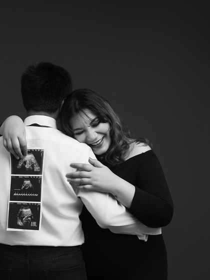 A hug filled with joy and excitement. Holding the ultrasound photos, the mother-to-be's happiness is infectious. This is a beautiful way to announce your joy to the world.