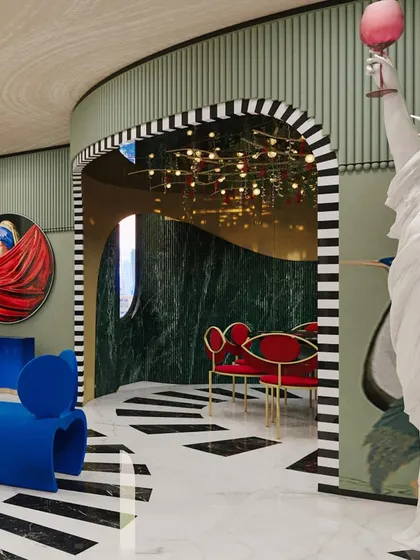 Another view of the living room, where a classic statue is playfully juxtaposed with modern art and bold furniture, creating a space that is both thoughtful and fun.
