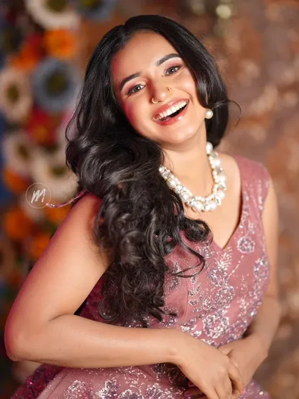 A big, happy smile from our model, showcasing a perfect party look.