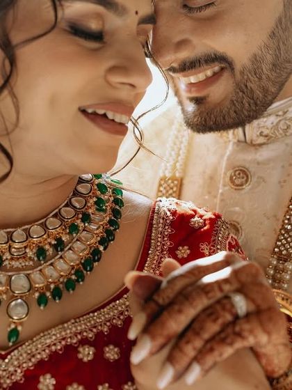 An intimate shot focusing on the couple's hands and the bride's beautiful jewelry, symbolizing their union.