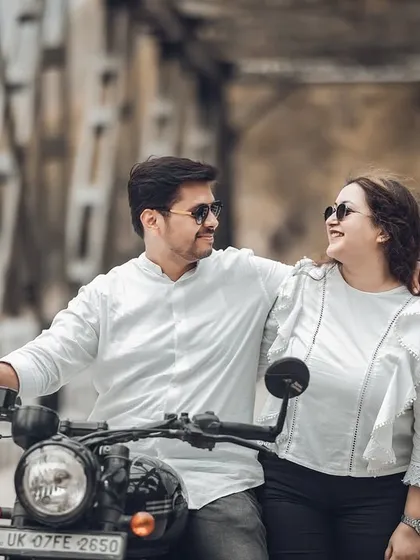 A close-up shot of the couple on the motorcycle, sharing a happy and genuine smile. This highlights their joy and the fun they're having during their engagement photoshoot.