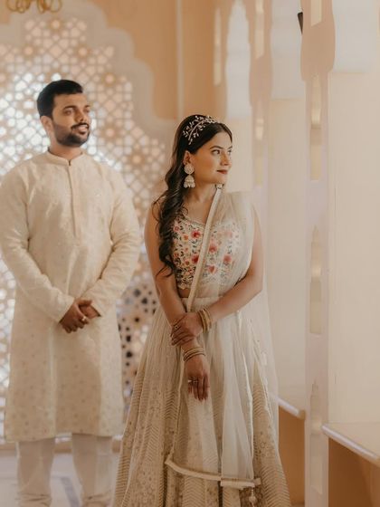 A beautiful pre-wedding shoot in a royal setting. The couple looks elegant in their white outfits, with the bride's makeup kept soft and natural.