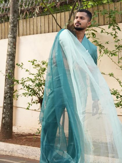 Another angle of the flowing teal suit, perfect for a designer lookbook.