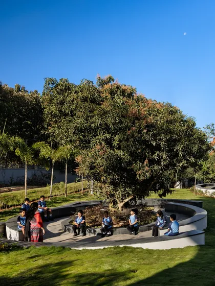 An outdoor classroom under a mature mango tree at Euro School, Bannerghatta. This image captures our belief in rooting education in the natural environment, creating spaces where lessons are enriched by the textures, rhythms, and realities of the outdoors.