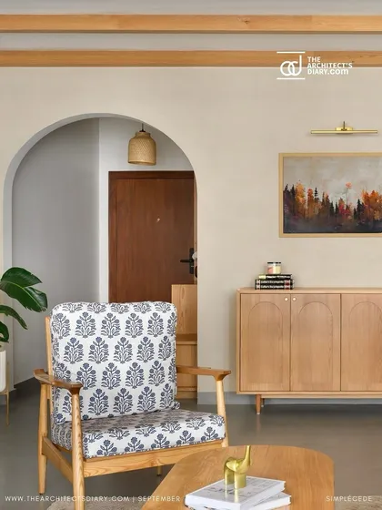This living room features a custom light oak sideboard set between two arched entryways, creating a harmonious and symmetrical composition.
