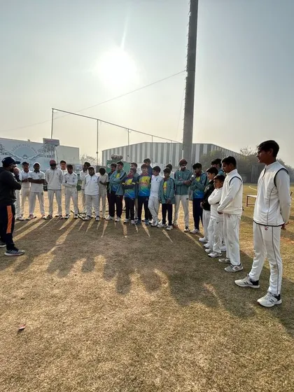 Coaching at our academy goes beyond drills. It's about mentorship, building character, and instilling a deep understanding of the game. Here, our head coach connects with players during a morning strategy session.