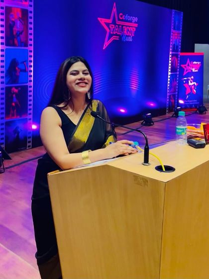 A candid smile from the podium at the Coforge Talent Hunt. I genuinely enjoy celebrating the talent within a company.