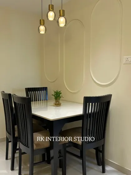 A simple yet elegant dining setup. I used wall mouldings and stylish pendant lights to define the dining nook and create a pleasant atmosphere for meals.