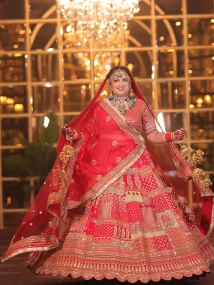 A grand, full-length shot of the bride, looking like a princess in her magnificent lehenga and jewellery.