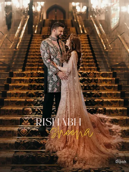 An engagement portrait on the grand staircase of a luxury hotel, capturing the couple in their exquisite traditional attire. This shot embodies the regal elegance and grandeur of a modern Indian love story.