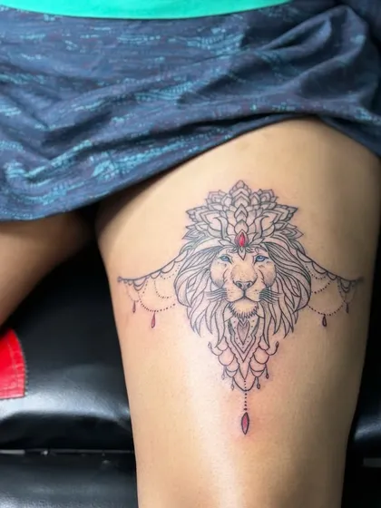 A slightly different angle of the ornamental lion thigh tattoo, showing the delicate linework and the gemstone detail.
