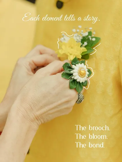 Each element tells a story. The brooch, the bloom, the bond. A mother's hands carefully pinning a flower on her son's kurta is a quiet moment of love.