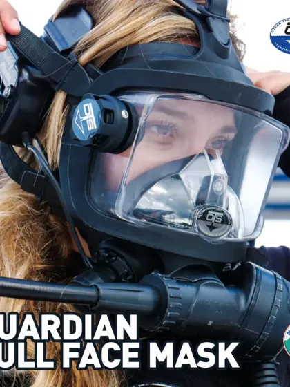 A diver adjusts her Guardian Full-Face Mask from Ocean Technology Systems. This mask is engineered for a perfect seal and exceptional comfort, featuring a double face seal and a smaller oral-nasal cavity, making it ideal for a wide range of face shapes.
