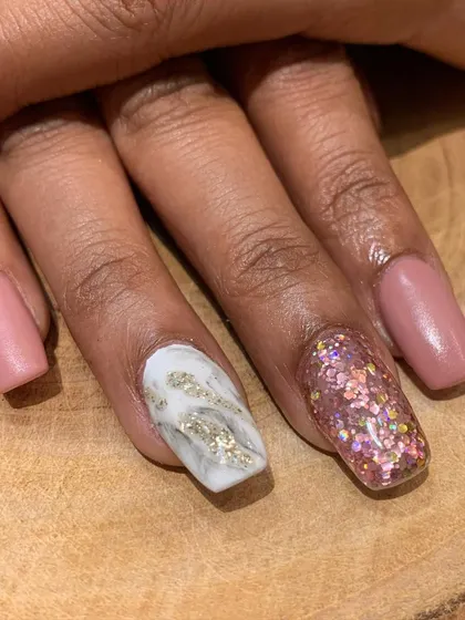 A close-up view of the glitter and marble accent nails. The contrast between the matte and sparkle is what makes this set so unique.