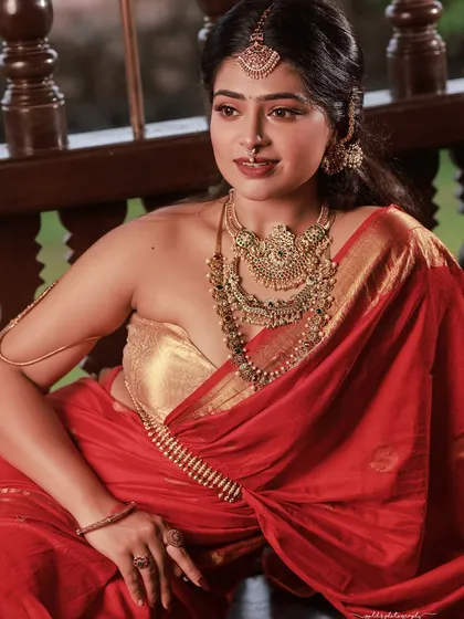 A classic South Indian traditional portrait. The focus here is on the rich details of the red and gold saree and the intricate temple jewelry. I use warm, soft lighting to create a timeless and elegant feel, perfect for bridal or festive photoshoots.