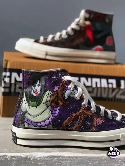 A focused view of the Orochimaru custom Converse, with the Itachi shoe blurred in the background. This shot emphasizes the vibrant colors and details of the galaxy and snake design.