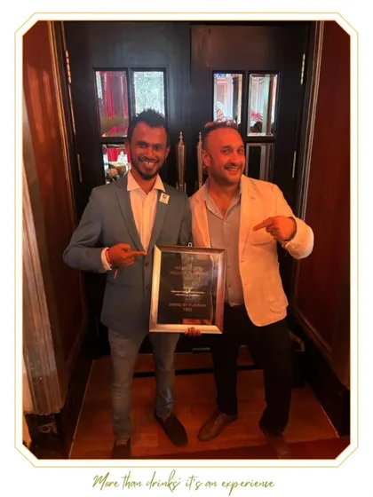 Another shot of our team members celebrating with a framed award. We believe in acknowledging every milestone and the people who make it possible.