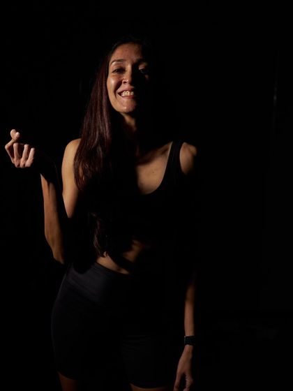 A portrait of one of our amazing instructors, radiating joy and strength in the studio.