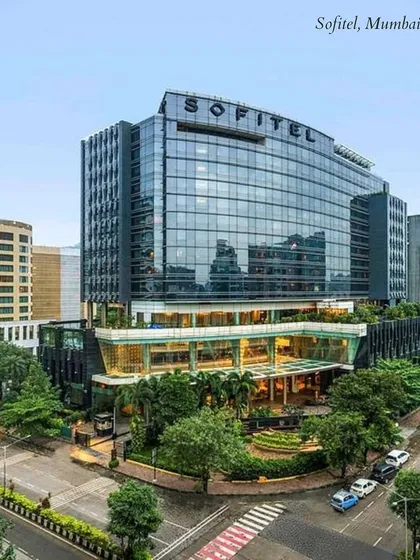 The modern glass facade of the Sofitel hotel in Mumbai's BKC. It's a prime location for a sophisticated corporate-style wedding with world-class amenities.