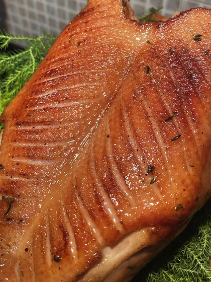 A beautifully roasted duck crown, with scored, crispy skin. This is the result of careful curing and rendering to achieve the perfect texture.