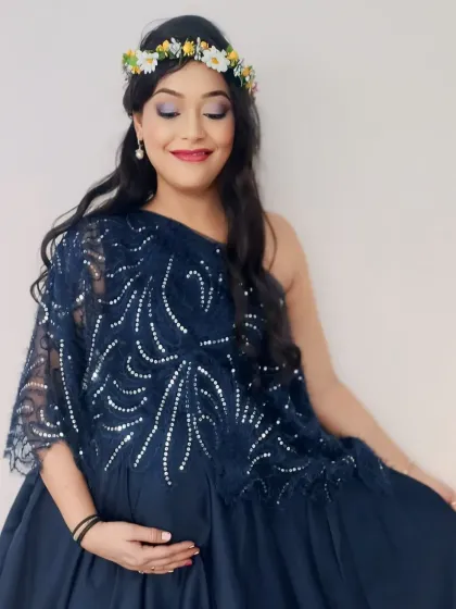 Elegant and refined, this navy blue gown features a one-shoulder design with intricate silver sequin detailing on a delicate lace overlay.