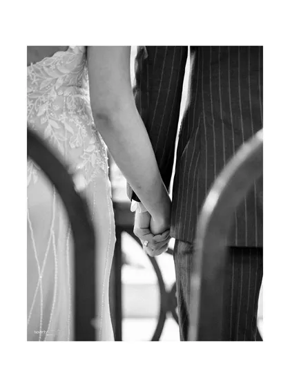 A simple yet powerful black and white shot of a couple holding hands during their wedding ceremony. It’s a quiet promise, a symbol of their united journey.