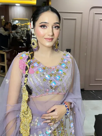 The traditional hairstyle and modern makeup create a beautiful fusion look.