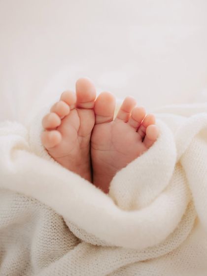 Ten perfect little toes peeking out from a soft, warm blanket. These are the details you will cherish forever.