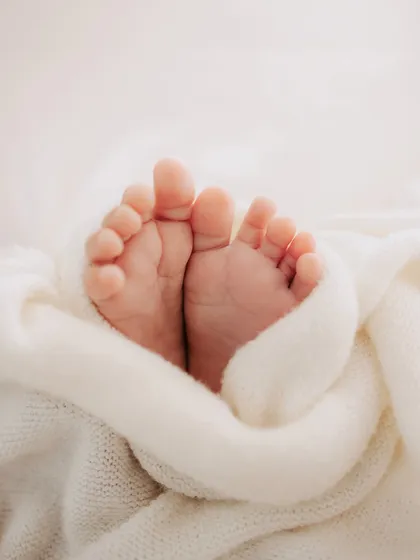 Ten perfect little toes peeking out from a soft, warm blanket. These are the details you will cherish forever.