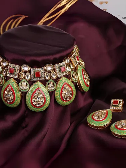 A close-up of one of my favorite Kundan and Meenakari sets. The vibrant green and red enamel work is entirely handcrafted, offering a regal look that is perfect for brides who want a touch of unique color.