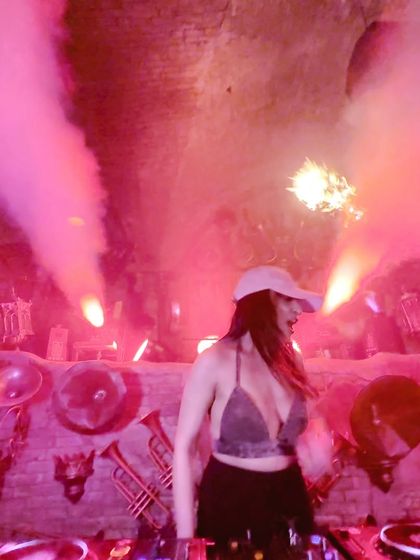 Surrounded by pink smoke and lights, completely in the zone. The atmosphere of a gig is everything, and I work with the lighting and effects to create a full sensory experience.