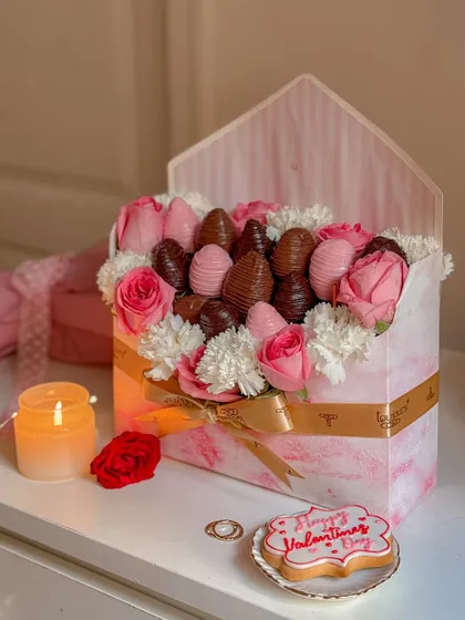 A romantic and luxurious Valentine's gift box designed to look like a love letter, filled with chocolate-dipped strawberries and fresh pink and white flowers. This is the perfect expression of love, combining classic romance with gourmet indulgence.