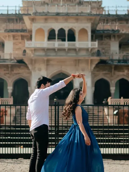 A playful dance in front of Albert Hall. The bride's flowing blue dress adds a beautiful sense of motion and color to this happy, candid pre-wedding photo.