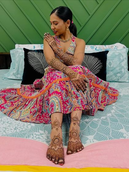 The stunning bride Sneha, relaxing and looking beautiful with her full bridal mehendi on her hands and feet.