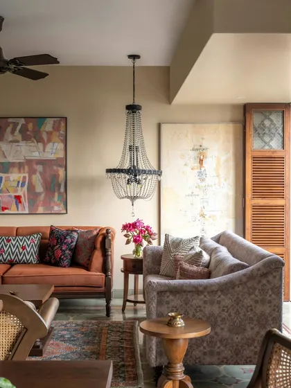 In this Calcutta home, the living room needed to hold the energy of a full-hearted joint family. We mixed earthy tones, worn-in woods, and vintage finds to create a space that feels generous and grounded. The elegant chandelier adds a touch of old-world charm, balancing nostalgia with a modern way of living.