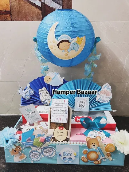 A beautiful and elaborate baby boy hamper with multiple themed elements and treats.