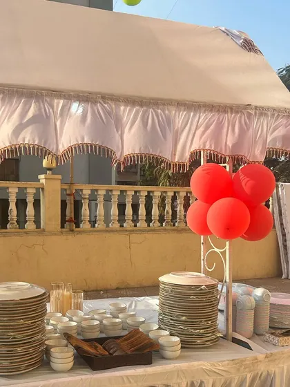 Getting the essentials right. I make sure there are plenty of plates, bowls, and cutlery, all neatly arranged and ready for your guests. It's these details that ensure a smooth event.
