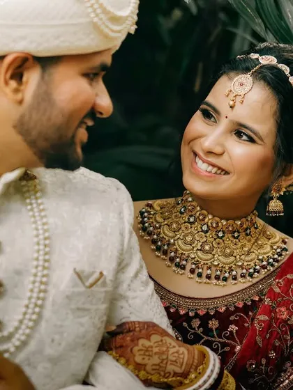 A close-up portrait of the bride and groom, their smiles radiating pure happiness. The bride's loving gaze at her husband makes this a truly special and candid moment.