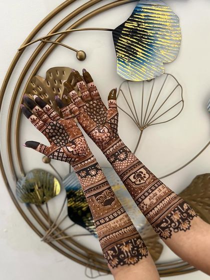 A beautiful indoor shot showcasing the complete bridal mehendi, with personalized elements and traditional motifs.