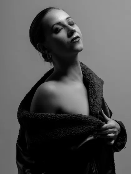 I love the quiet power of black and white. This monochrome portrait focuses on pure emotion, using soft, directional light to sculpt the subject's features and create a timeless, introspective mood.