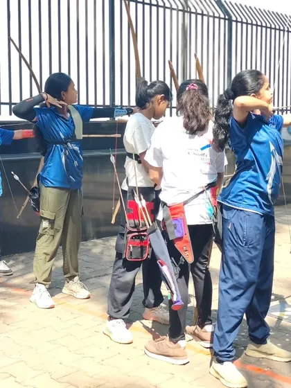 A line of young female archers at our girls' selection trials. We are committed to empowering girls in sports.