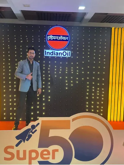 Standing in front of the branded backdrop for the IndianOil "Super 50" event.
