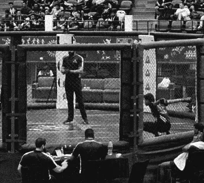 A powerful black and white shot of the cage before a fight. This is the arena where our warriors prove their mettle. In this game, it's either tap or nap.