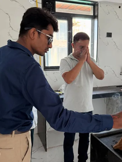 Performing a small pooja with the client in the kitchen area to bless the new project and ensure a smooth process.